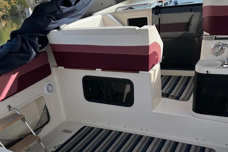 Slide: The Image of 1988 Silverton 34X Express boat interior with striped flooring and maroon seating. - 8