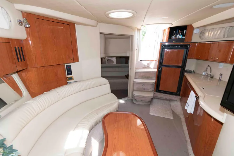 Slide: The Image of Interior of 2000 Sea Ray 410 Sundancer yacht with kitchen and seating area. - 10