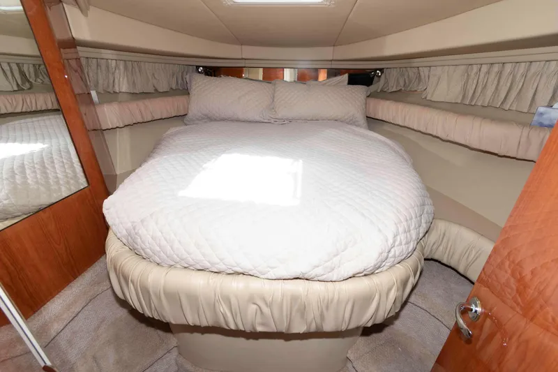 Slide: The Image of Interior cabin of 2000 Sea Ray 410 Sundancer with cozy bed and elegant decor. - 12