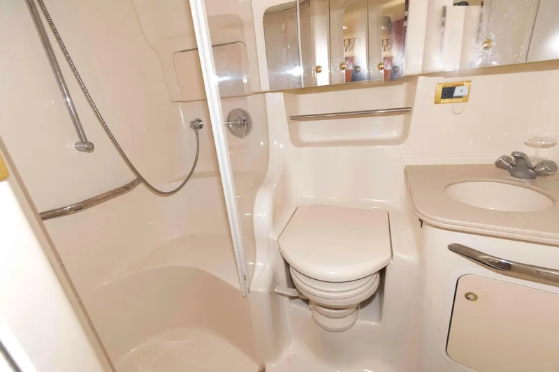 Slide: The Image of Bathroom interior of 2000 Sea Ray 410 Sundancer yacht, featuring shower and toilet. - 13
