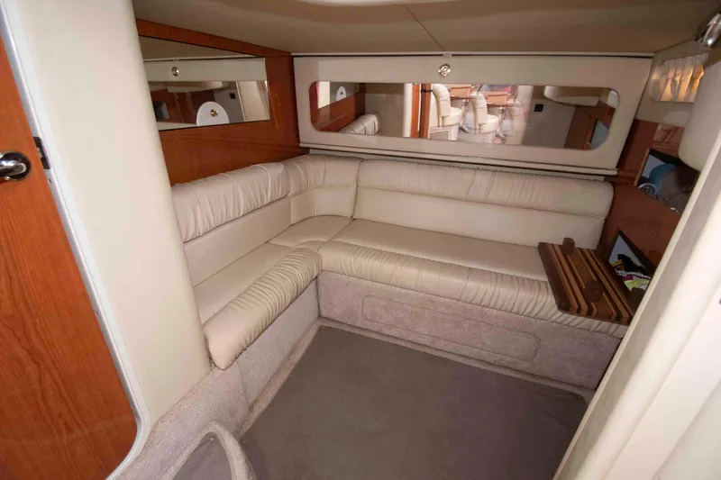 Slide: The Image of Interior of 2000 Sea Ray 410 Sundancer with beige leather seating and wood accents. - 14