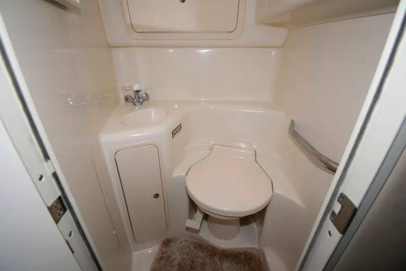 Slide: The Image of 2000 Sea Ray 410 Sundancer bathroom with compact toilet and sink. - 15