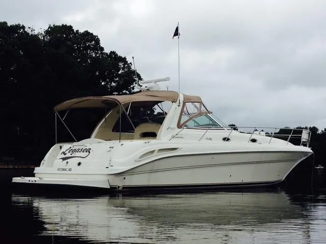 Slide: The Image of 2000 Sea Ray 410 Sundancer yacht on calm water, overcast sky. - 2