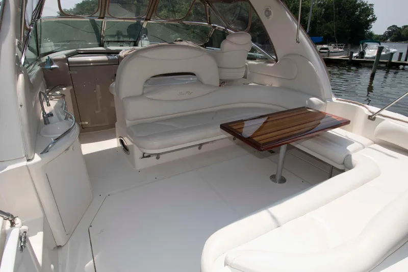 Slide: The Image of Luxurious 2000 Sea Ray 410 Sundancer yacht interior with elegant seating and wooden table. - 3