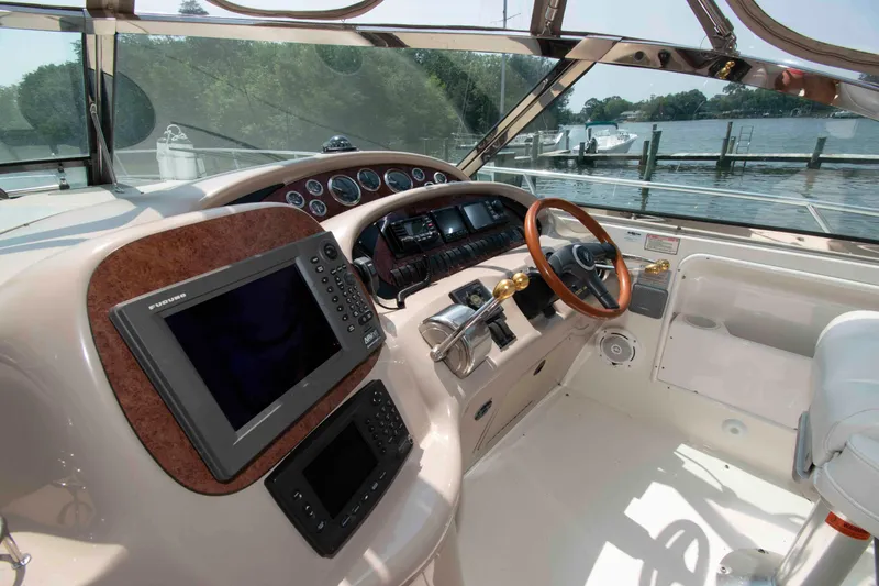 Slide: The Image of Cockpit of 2000 Sea Ray 410 Sundancer with navigation equipment and wooden steering wheel. - 5