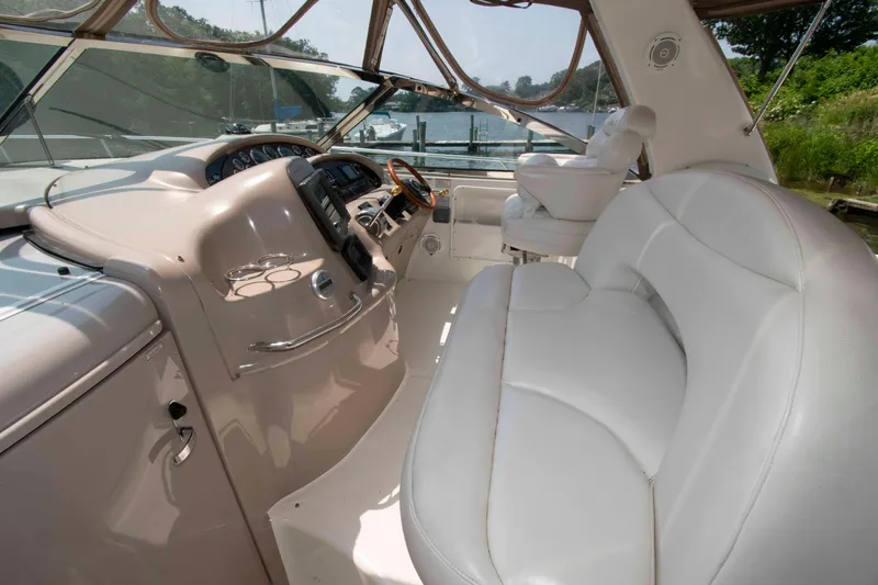 Slide: The Image of 2000 Sea Ray 410 Sundancer cockpit with white seating and control panel. - 6