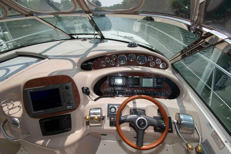 Slide: The Image of Cockpit of 2000 Sea Ray 410 Sundancer yacht with steering wheel and navigation instruments. - 7
