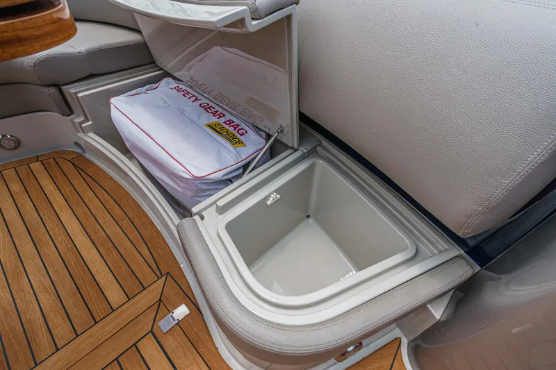 Slide: The Image of Storage compartment on Riva 44 RivaRama 2006, featuring safety gear bag and wooden flooring. - 25