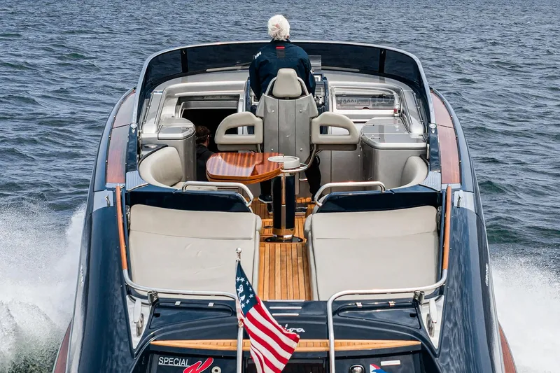 Slide: The Image of Luxury Riva 44 RivaRama yacht cruising on open water, rear view, American flag displayed. - 27