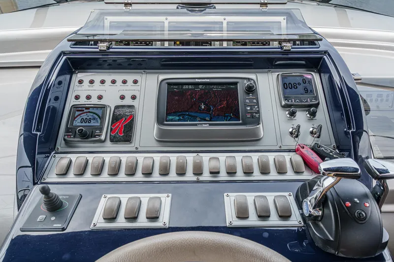 Slide: The Image of Control panel of a 2006 Riva 44 RivaRama yacht with navigation instruments and controls. - 37