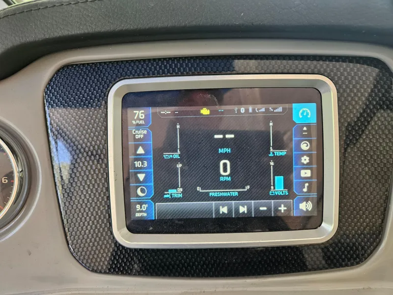 Slide: The Image of Dashboard display of a 2018 Chaparral 21 H2O Surf boat showing speed and system metrics. - 10