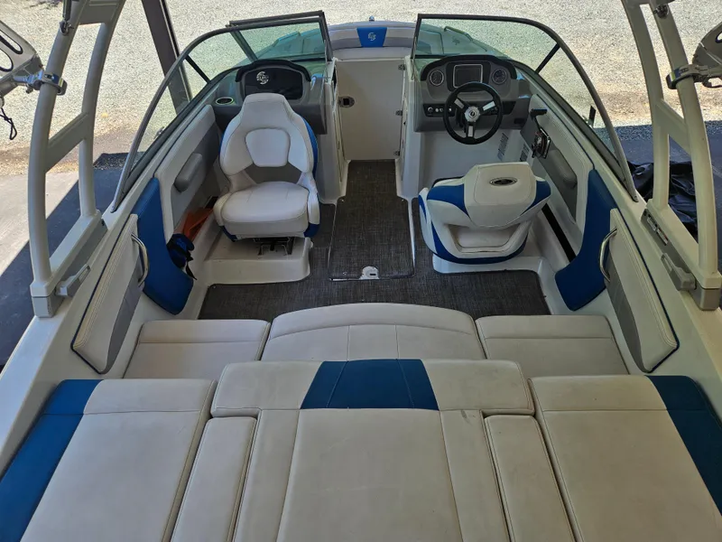 Slide: The Image of 2018 Chaparral 21 H2O Surf boat interior with seating and steering wheel. - 6