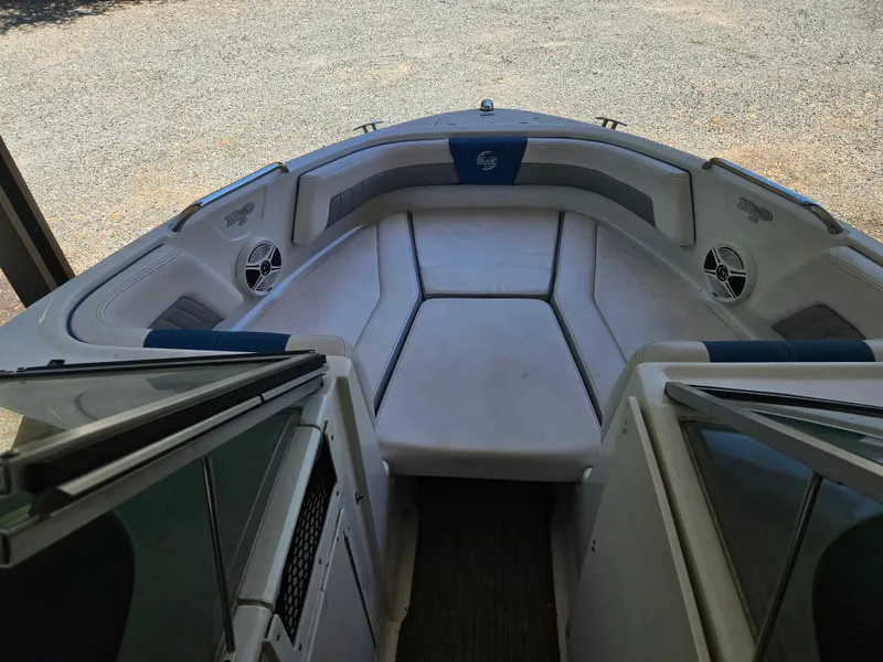 Slide: The Image of 2018 Chaparral 21 H2O Surf boat interior with cushioned seating and speakers. - 8