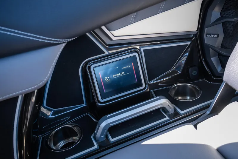 Slide: The Image of 2025 Tigé Ultré 23ZX interior touchscreen display with cup holders and sleek design. - 11