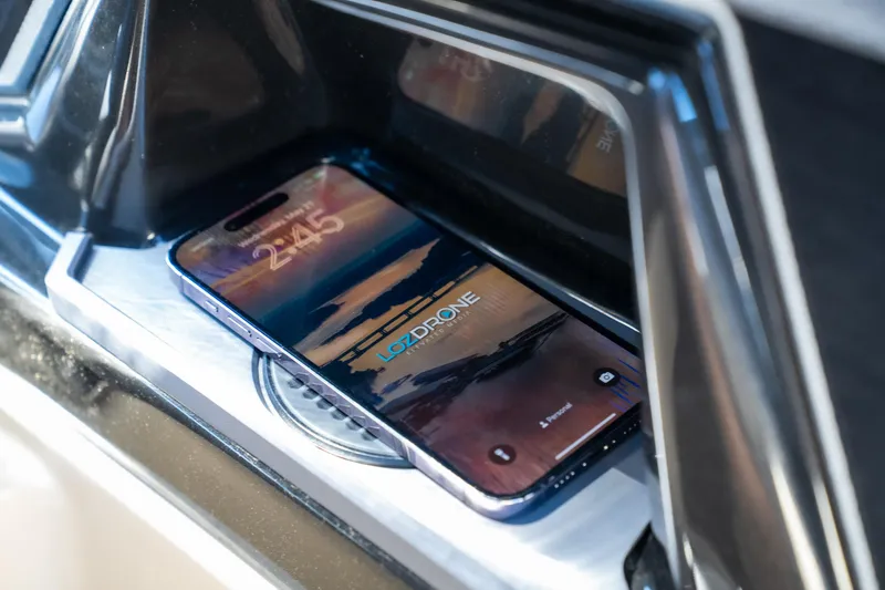 Slide: The Image of Smartphone on Tigé Ultré 23ZX 2025 dashboard, displaying a scenic wallpaper. - 13