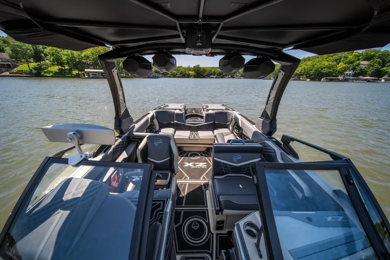 Slide: The Image of 2025 Tigé Ultré 23ZX boat interior with sleek design on a serene lake. - 25