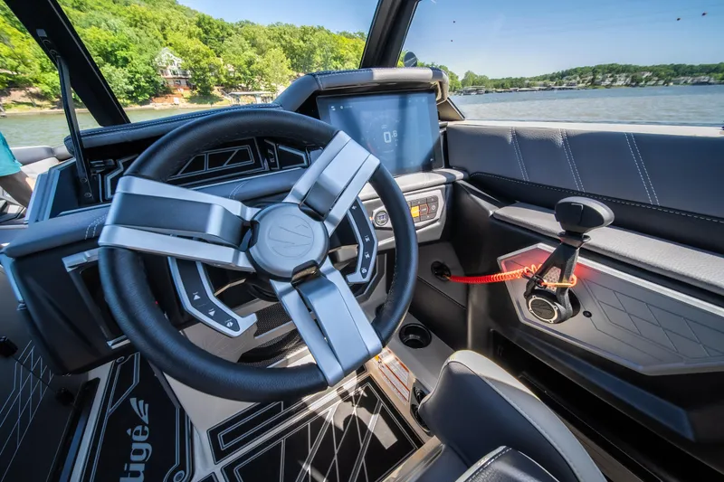 Slide: The Image of 2025 Tigé Ultré 23ZX boat interior with modern steering wheel and dashboard controls. - 27