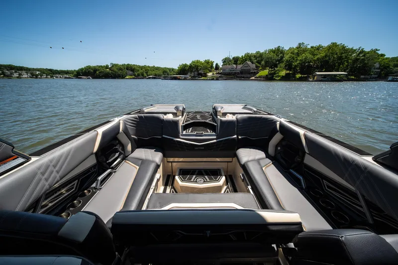 Slide: The Image of 2025 Tigé Ultré 23ZX boat interior with luxurious seating on a sunny lake. - 31