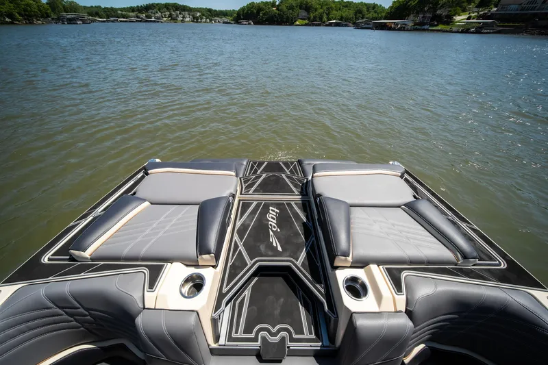 Slide: The Image of 2025 Tigé Ultré 23ZX boat with luxurious seating on a serene lake. - 32
