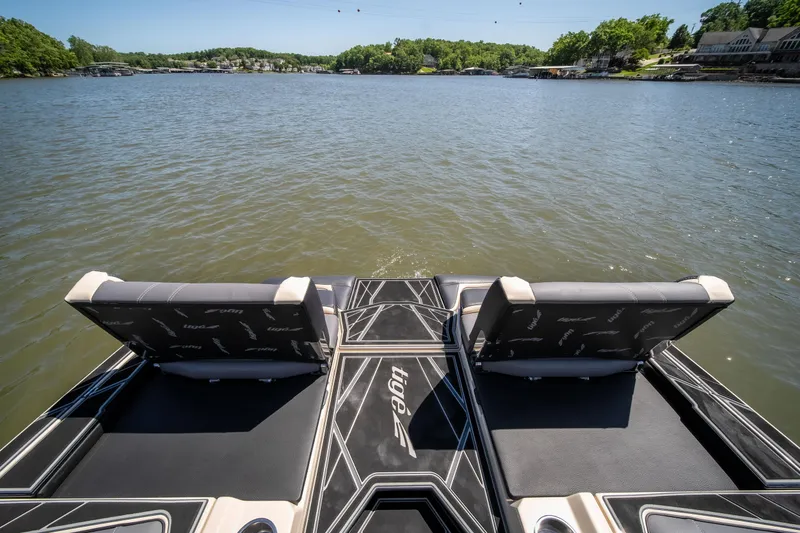 Slide: The Image of 2025 Tigé Ultré 23ZX boat with rear seating, overlooking a serene lake. - 33