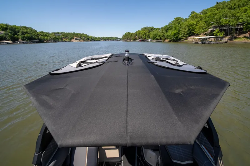 Slide: The Image of 2025 Tigé Ultré 23ZX boat with canopy on a scenic lake. - 38