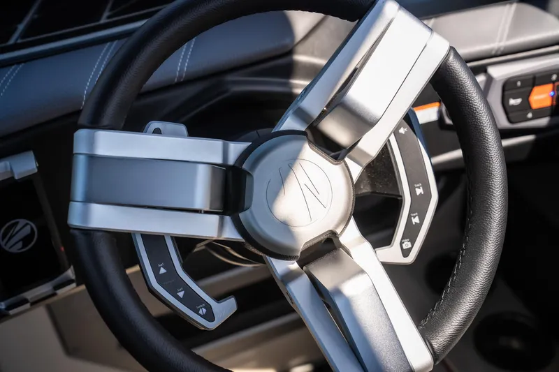Slide: The Image of Steering wheel of 2025 Tigé Ultré 23ZX boat, featuring modern design and controls. - 46