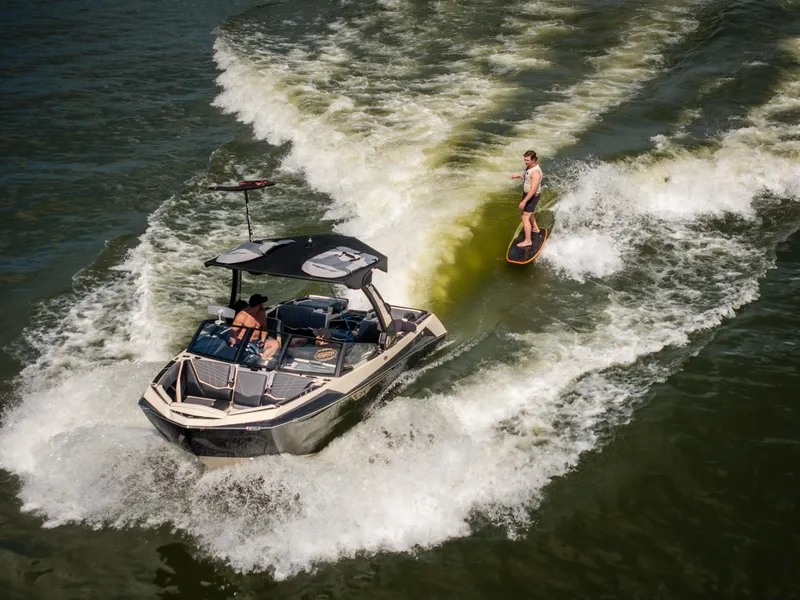 Slide: The Image of 2025 Tigé Ultré 23ZX boat towing a wakeboarder on a sunny day. - 6