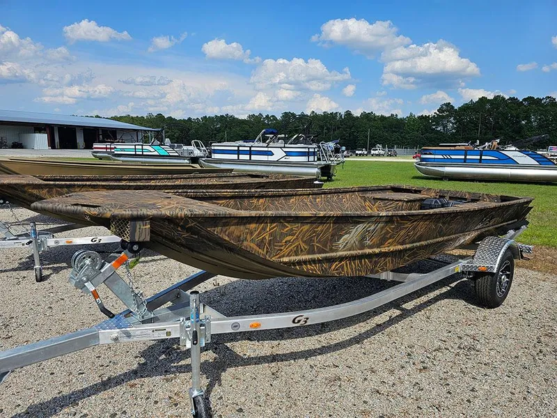 Slide: The Image of 2025 G3 Gator Tough 15 DK boat on trailer, camo design, outdoor display. - 11
