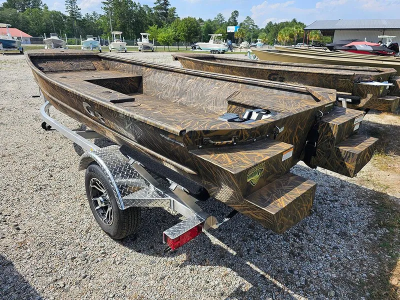 Slide: The Image of 2025 G3 Gator Tough 15 DK boat on trailer, camo design, parked outdoors. - 12