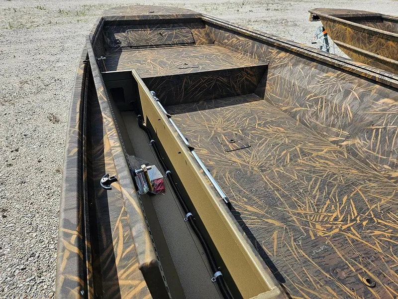 Slide: The Image of 2025 G3 Gator Tough 15 DK boat with camo interior, parked on gravel. - 15