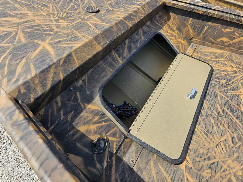 Slide: The Image of 2025 G3 Gator Tough 15 DK boat with open storage compartment, camo pattern. - 17