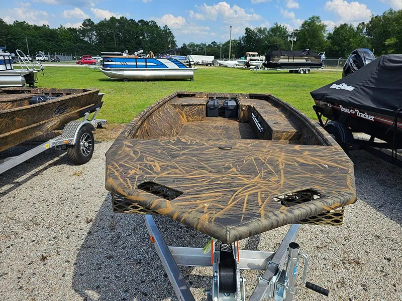 Slide: The Image of 2025 G3 Gator Tough 15 DK boat with camouflage design on a trailer, parked outdoors. - 8