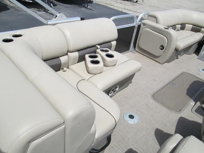 Slide: The Image of 2023 Sun Tracker PARTY BARGE 22RF XP3 interior with beige seating and cup holders. - 11