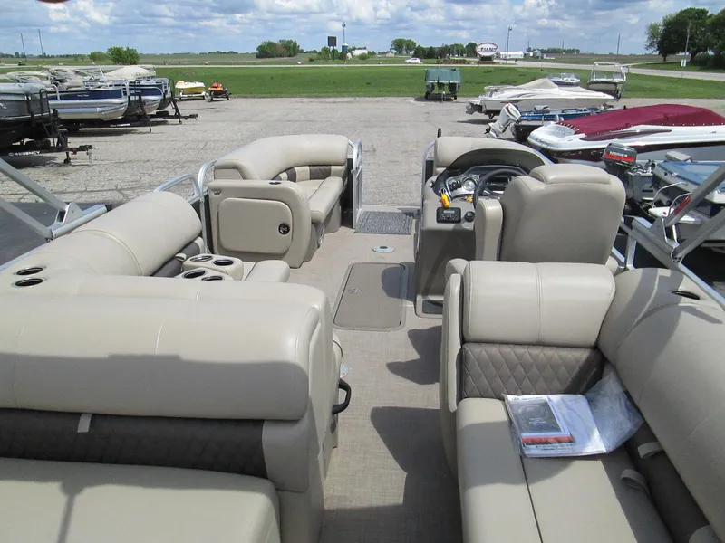 Slide: The Image of 2023 Sun Tracker PARTY BARGE 22RF XP3 pontoon boat with beige seating, parked outdoors. - 13