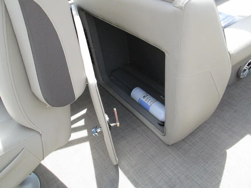 Slide: The Image of 2023 Sun Tracker PARTY BARGE 22RF XP3 storage compartment with open door and visible fire extinguisher. - 18