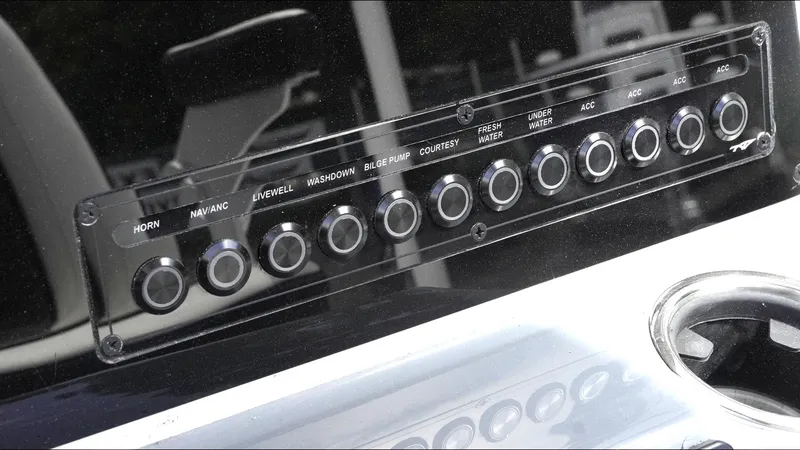 Slide: The Image of Control panel of 2025 Tidewater 198 CC Adventure boat with labeled buttons. - 12