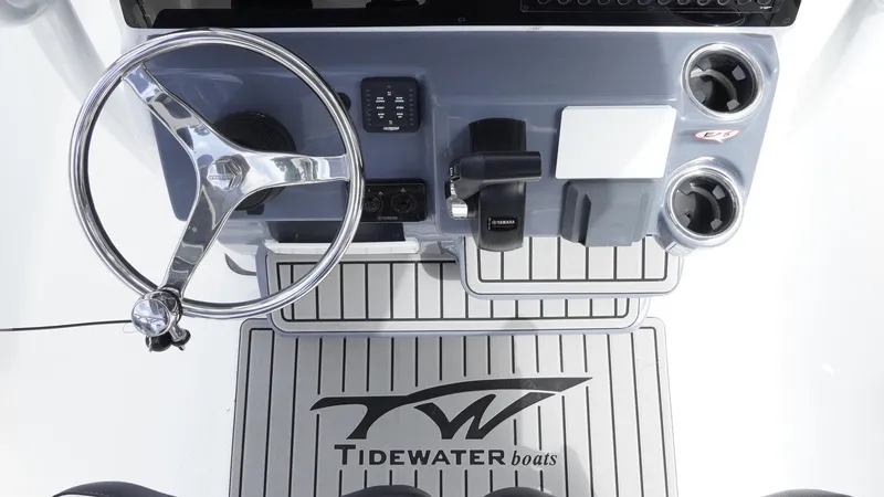 Slide: The Image of 2025 Tidewater 198 CC Adventure boat console with steering wheel and controls. - 14
