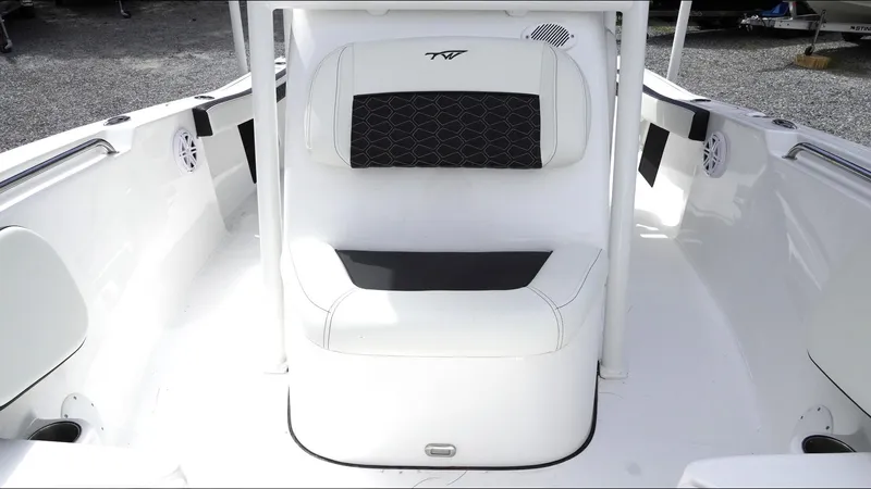 Slide: The Image of 2025 Tidewater 198 CC Adventure boat interior with white seating and black accents. - 17