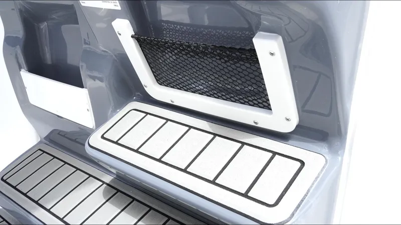 Slide: The Image of 2025 Tidewater 198 CC Adventure boat interior with storage net and non-slip flooring. - 22