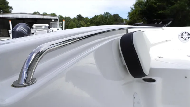 Slide: The Image of 2025 Tidewater 198 CC Adventure boat, featuring sleek chrome railing and cushioned detail. - 25