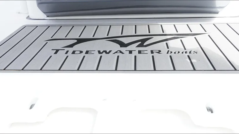 Slide: The Image of 2025 Tidewater 198 CC Adventure boat deck with logo, featuring sleek design and branding. - 27