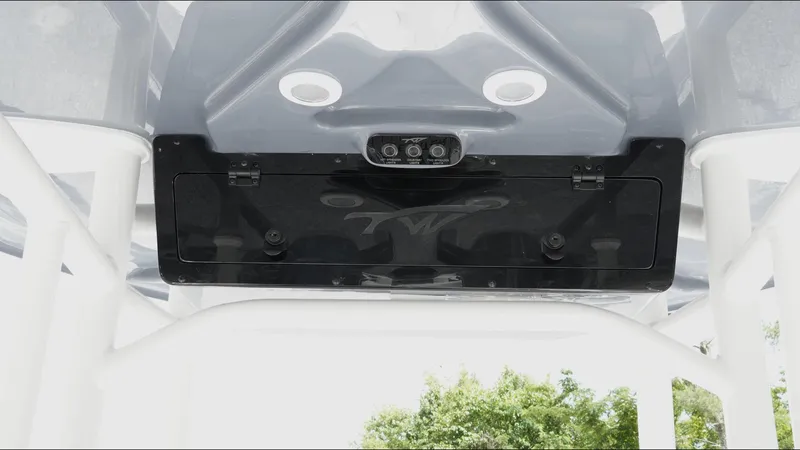 Slide: The Image of 2025 Tidewater 198 CC Adventure boat console with speakers and storage compartment. - 28