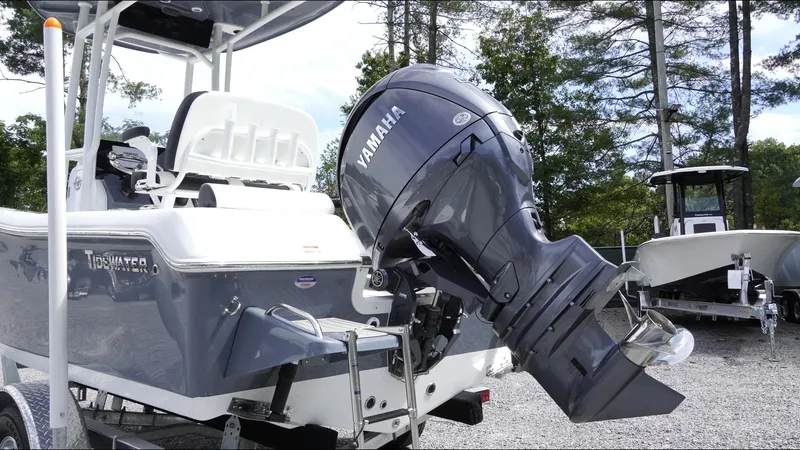 Slide: The Image of 2025 Tidewater 198 CC Adventure boat with Yamaha outboard motor, parked on gravel. - 32