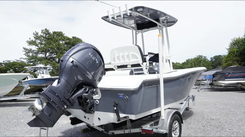 Slide: The Image of 2025 Tidewater 198 CC Adventure boat on trailer, featuring a powerful outboard motor. - 33