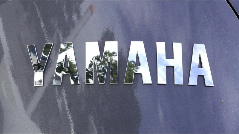 Slide: The Image of Yamaha logo on 2025 Tidewater 198 CC Adventure boat, reflecting sky and trees. - 34