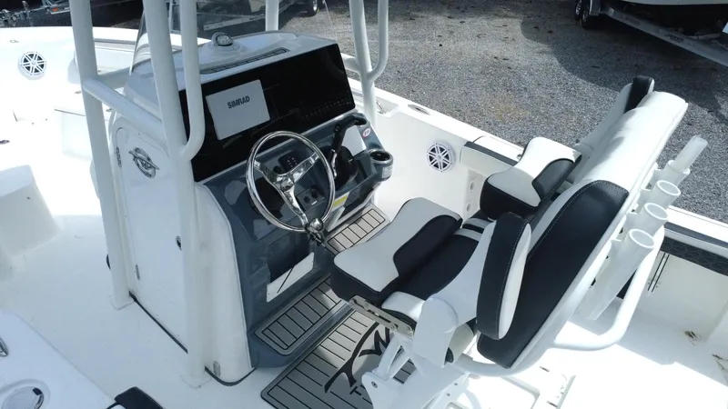 Slide: The Image of 2025 Tidewater 198 CC Adventure boat interior with steering console and seating. - 6