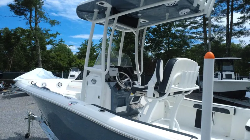 Slide: The Image of 2025 Tidewater 198 CC Adventure boat with center console and seating, docked outdoors. - 7