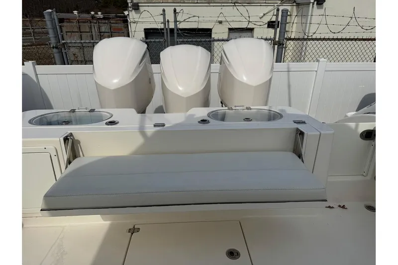 Slide: The Image of 2017 Cobia 344 Center Console boat with triple engines and seating area. - 11
