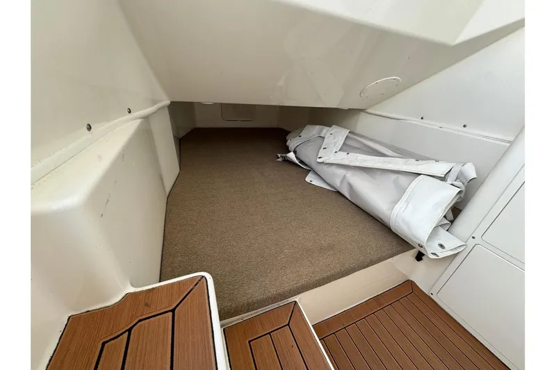 Slide: The Image of 2017 Cobia 344 Center Console cabin interior with rolled-up canvas cover. - 14
