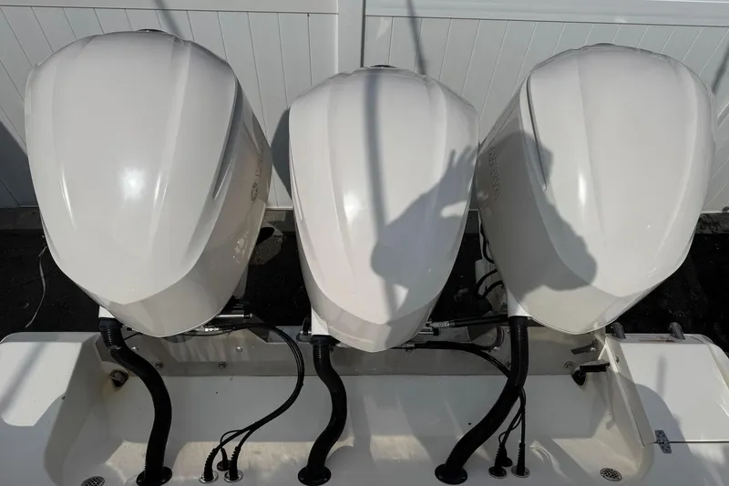 Slide: The Image of Three outboard motors on a 2017 Cobia 344 Center Console boat. - 15